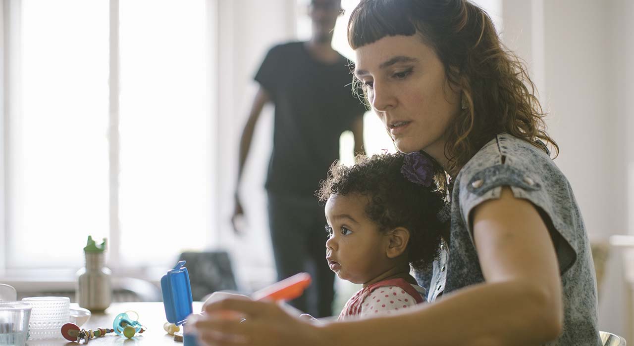 Women working from home with child on her lap